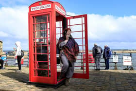 Suzie Devey makes a call at her art installation on the seafront.
194425j