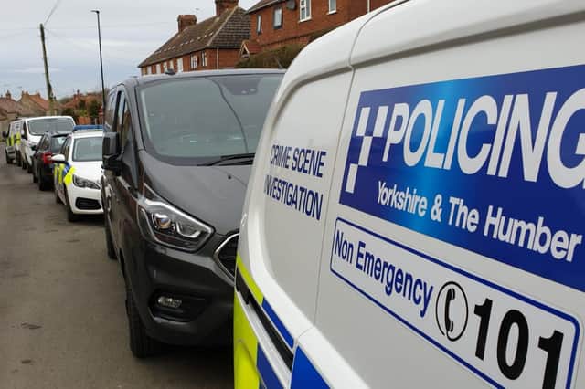 A large number of police vehicles at the scene in Thornton-le-Dale, including a Crime Scene Investigation van.