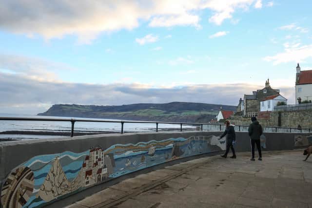 Part of the sea wall at Robin Hood's Bay, near Whitby - picture in 2016 when a mosaic was installed along part of the wall.