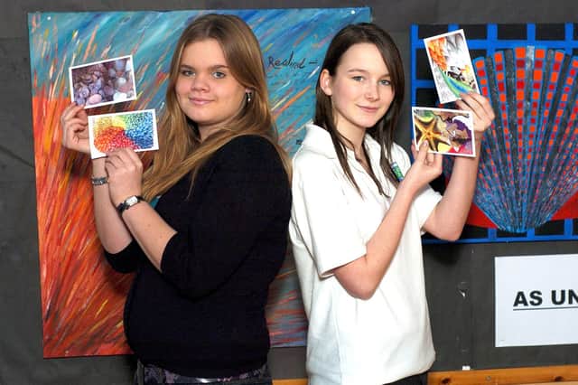 Lucy Williamson and Charlotte Miller show off their postcard designs.