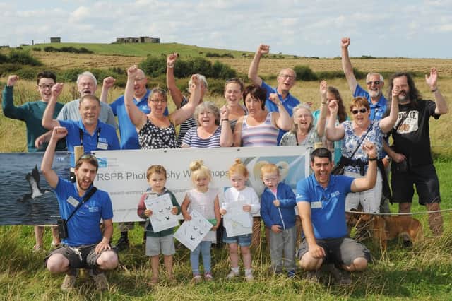 RSPB Bempton Cliffs staff, volunteers and visitors celebrate in 2014 after the popular nature reserve landed a grant award. Do you recognise any of the people in the photograph. Picture taken by Paul Atkinson. (NBFP PA1432-3b)