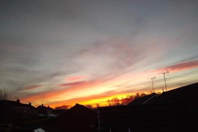 This image featuring a yellow and orange streaked sky was snapped by John Simmons.