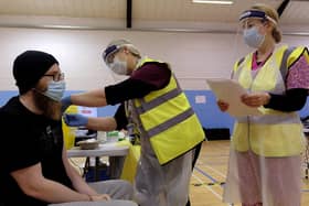 A patient receives their coronavirus vaccination at Scarborough Rugby Club.