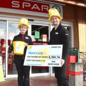 Staff at East Ayton SPAR with a cheque for £4,194