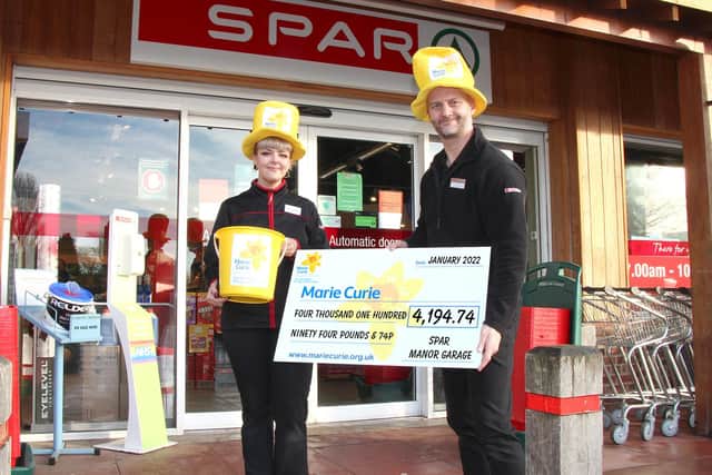 Staff at East Ayton SPAR with a cheque for £4,194
