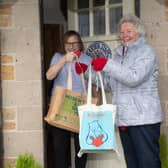 From left, May Reeve receiving a home delivery from volunteers Carol Beswick and Joan Ferguson.