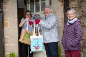 From left, May Reeve receiving a home delivery from volunteers Carol Beswick and Joan Ferguson.