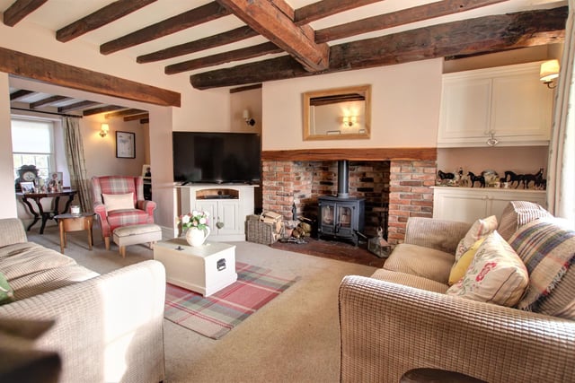 The stone fireplace is a focal point of this beamed sitting room.