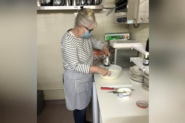 Whitby Town Mayor Cllr Linda Wild makes the cheesecake fit for a Queen.