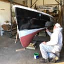 The coble Venus is given a new coat of paint.