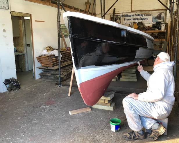 The coble Venus is given a new coat of paint.
