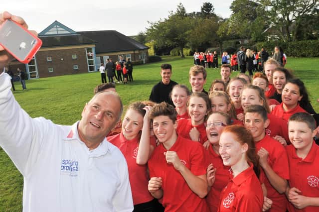 Olympic gold medal winner Sir Steve Redgrave takes a selfie with pupils during his visit to Burlington Junior School in 2014. Do you recognise any of the people in the photograph. (nbfp-msh1441x600)