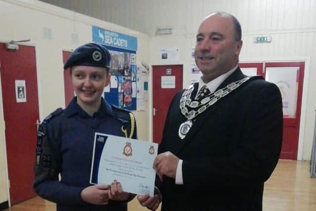 Bridlington Town Mayor Liam Dealtry presents a certificate of commendation from Central and East Yorkshire Wing to Cadet Warrant Officer Rosie Gregson.