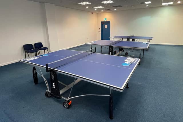It includes three table tennis tables and the bats and balls needed to play.