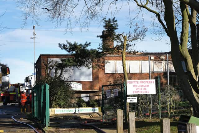 Firefighters clear up at the site