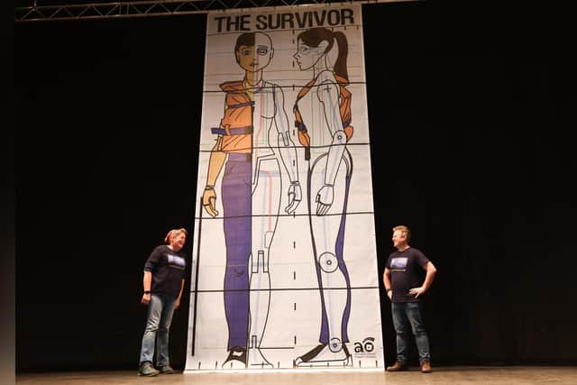 The full-size drawings of The Survivor puppet displayed vertically in the Grand Hall at Scarborough Spa.