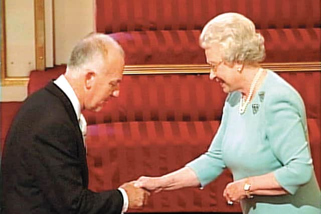 Richard Constantine accepts his MBE from the Queen. Richard was coxswain from 1994-2003.