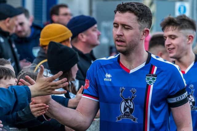 Whitby Town skipper Daniel Rowe shakes hands with the Blues fans after marking his 100th game with crucial goal in Bamber Bridge win

Photos by Brian Murfield