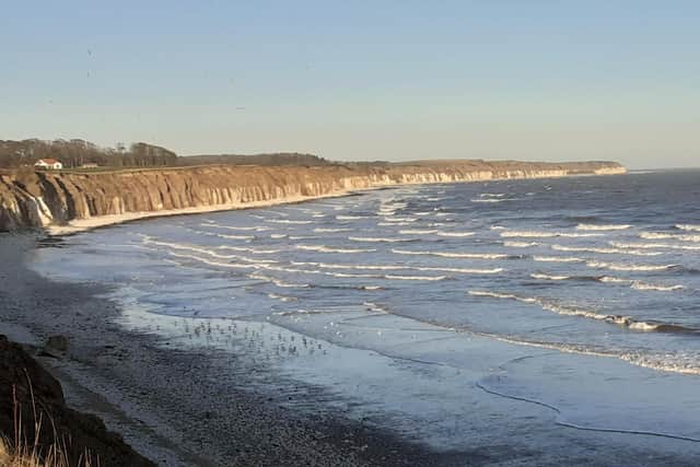 The yellow-tinged cliffs and white waves are the focus of this photo taken by Gary Sollitt.