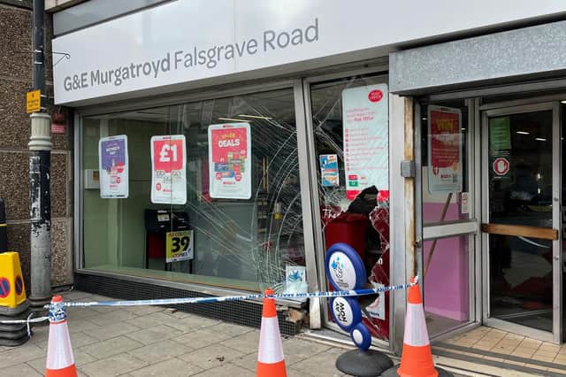 The shop's door and main window were badly damaged, with a large hole in the window.