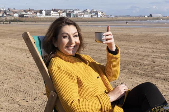 Jane McDonald enjoys a well-earned rest on the beach after battling with a deck chair and wind break. Photo courtesy of Channel 5 Data.