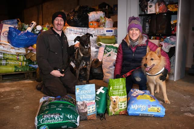 Paul and Sarah Marley with dogs Charlie and Trevor and donated animal items destined for the Ukraine