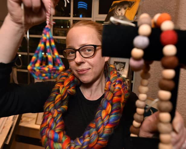 Designer Charlotte Hill with some of her jewellery made from textiles