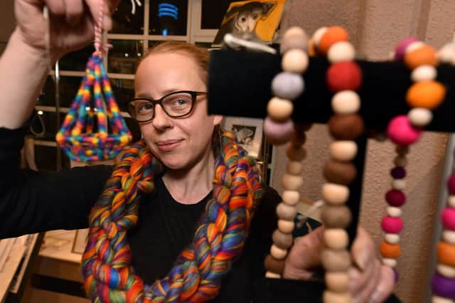 Designer Charlotte Hill with some of her jewellery made from textiles