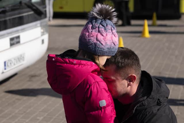 A father says goodbye to his daughter at Lviv station, before she boarded a bus to the border with Poland (Photo by Dan Kitwood/Getty Images)