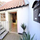 A private rear yard leads to a raised deck area.