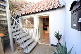 A private rear yard leads to a raised deck area.