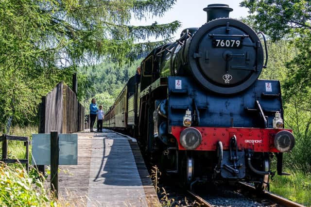 Passengers waiting to board a steam train.