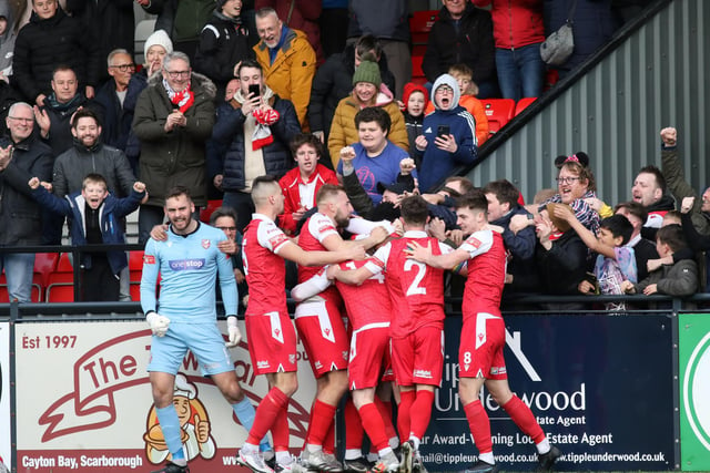 The fans and players celebrate Kieran Weledji's late leveller for Scarborough Athletic against Stafford Rangers