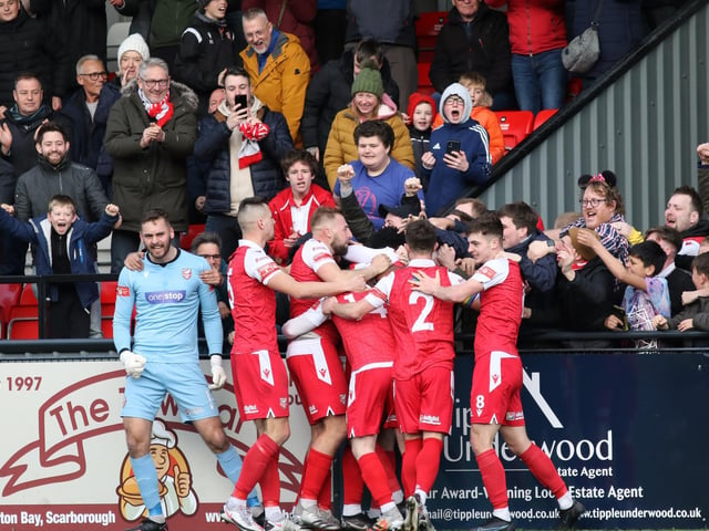 The fans and players celebrate Kieran Weledji's late leveller for Scarborough Athletic against Stafford Rangers