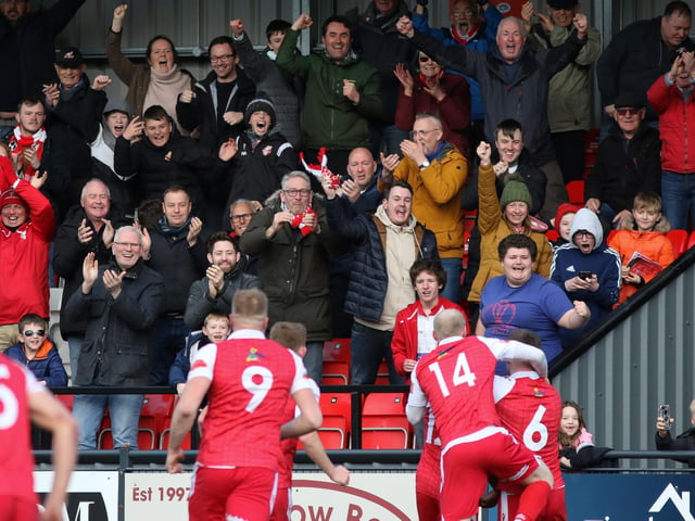 The fans and players celebrate Kieran Weledji's late leveller for Scarborough Athletic against Stafford Rangers