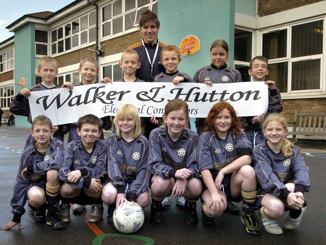 Braeburn School's mixed soccer team in their sponsored strip, pictured with teaching assistant Gary Lawton.