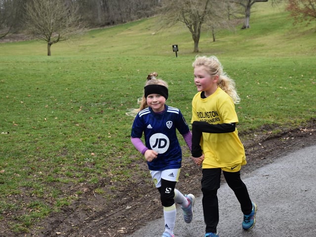 Two young runners work together at Sewerby parkrun