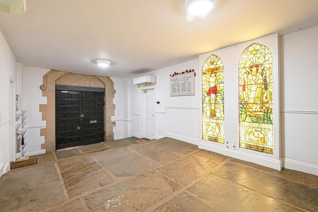 Stained glass windows add colour and interest to the entrance hall.