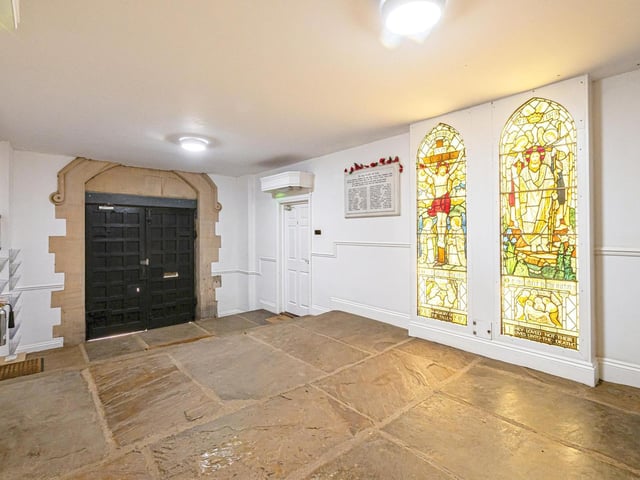 Stained glass windows add colour and interest to the entrance hall.