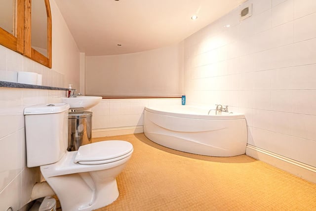 The corner bath is a feature of this bathroom.