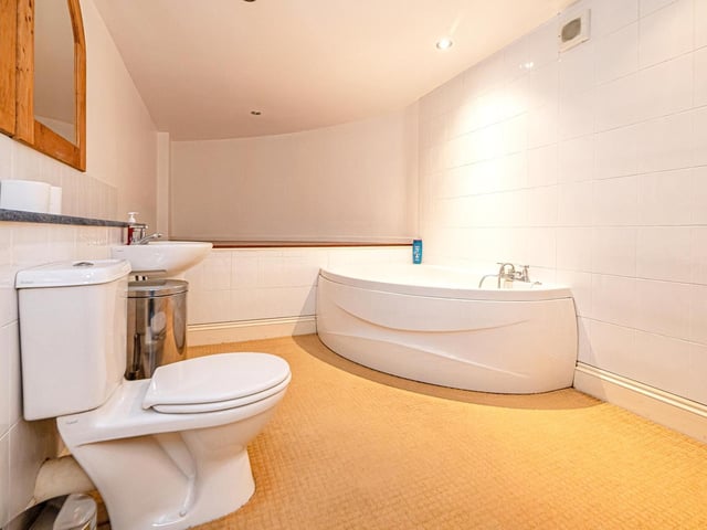 The corner bath is a feature of this bathroom.