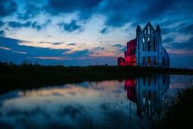 Whitby Abbey lit up.