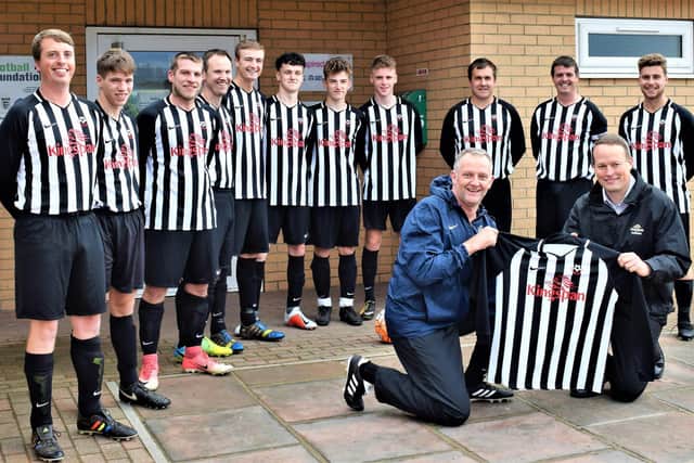 Sherburn FC pictured before the start of the 2018-19 season, with player-boss Andy Adamson receiving a new sponsored kit from Kingspan's Gary Owen