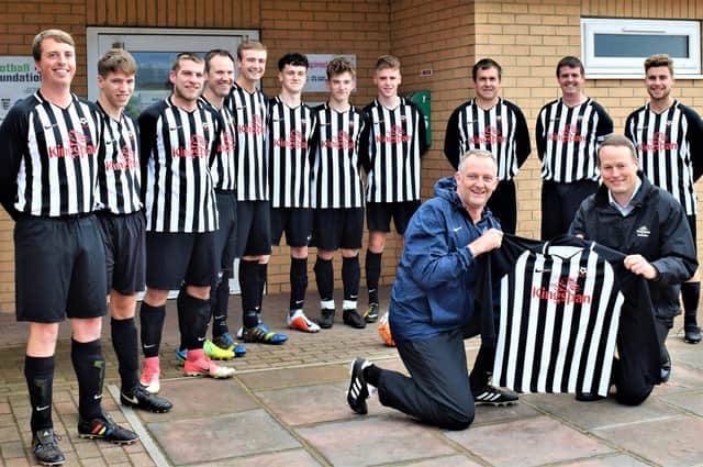 Sherburn FC pictured before the start of the 2018-19 season, with player-boss Andy Adamson receiving a new sponsored kit from Kingspan's Gary Owen