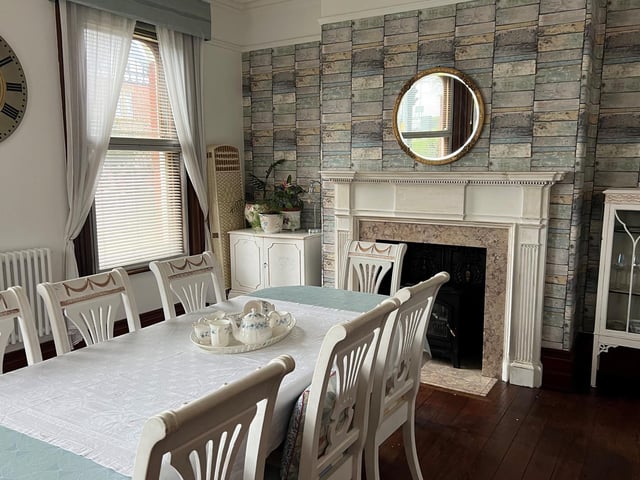 An Edwardian fireplace, and ample space for a large table and chairs.
