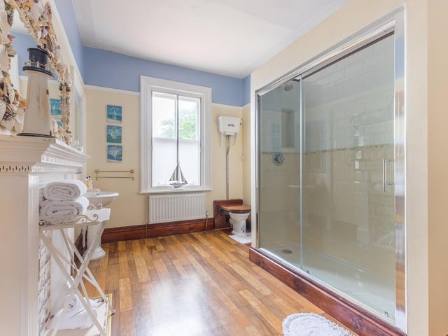 Even this modern and spacious shower room has period detail in its fireplace.