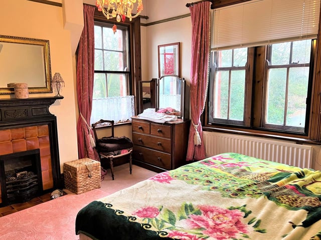 Sash windows and a feature fireplace in this room that has views over gardens.