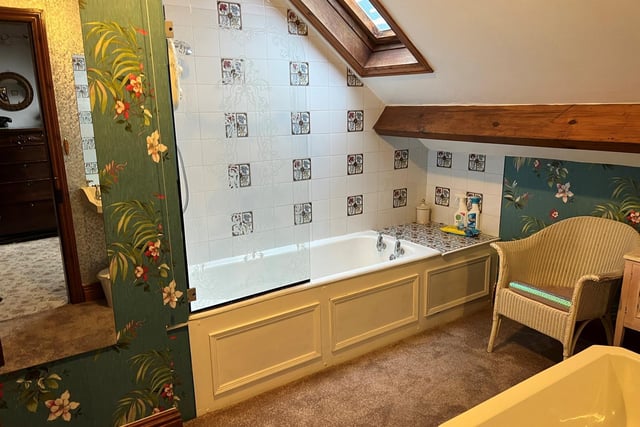 A quirky upstairs bathroom with oriental style wallpaper.
