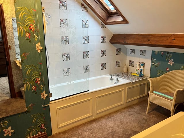 A quirky upstairs bathroom with oriental style wallpaper.