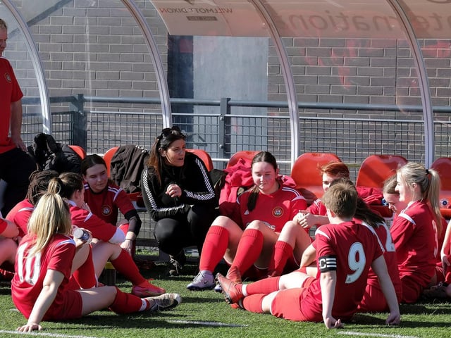 The Scarborough Ladies Under-18s players listen to their final ever half-time team talk from coach Rachel Paterson and manager Kevin Matthews